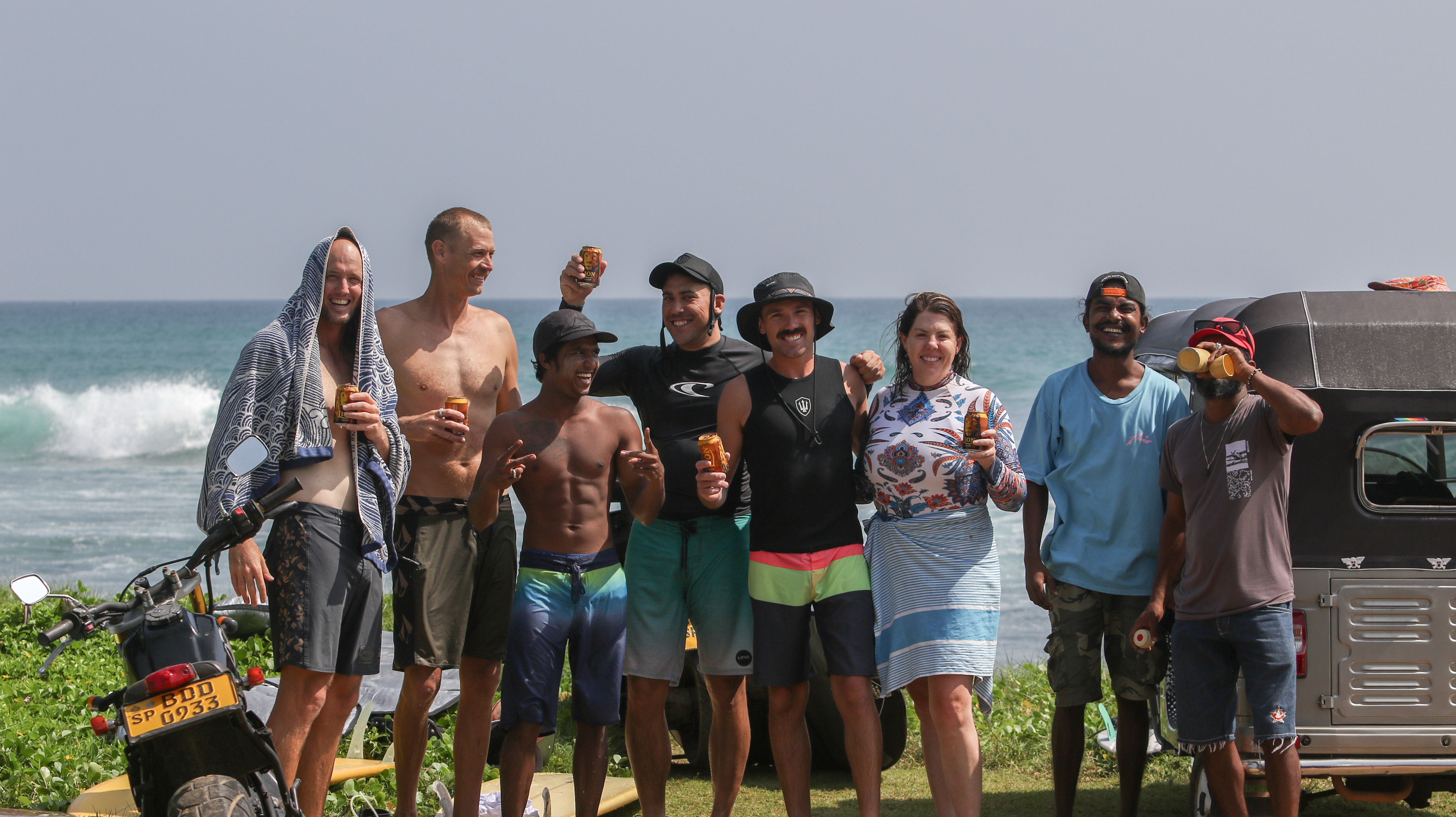 Rhythm & Flow guests and local guides gathered beside the ocean after a surf session